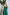 ELAGIA emerald green jumpsuit lifestyle shot demonstrating versatile styling options