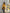 ELAGIA mustard trench coat styled detail shot highlighting lapels and button closure