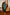 ELAGIA Emerald One-Shoulder Satin Midi Dress - model wearing dress showing movement and fabric flow