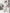 ELAGIA white one-shoulder satin midi dress movement shot showing dress flow and drape