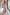 ELAGIA beige V-neck sleeveless jumpsuit back view - blue jumpsuit design showing rear silhouette and fit