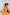 ELAGIA mustard polka dot suit set back view showing flowing maxi skirt and cropped top 3 piece women's suit
