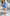 ELAGIA blue one-shoulder mini dress lifestyle photo showing dress worn in natural setting